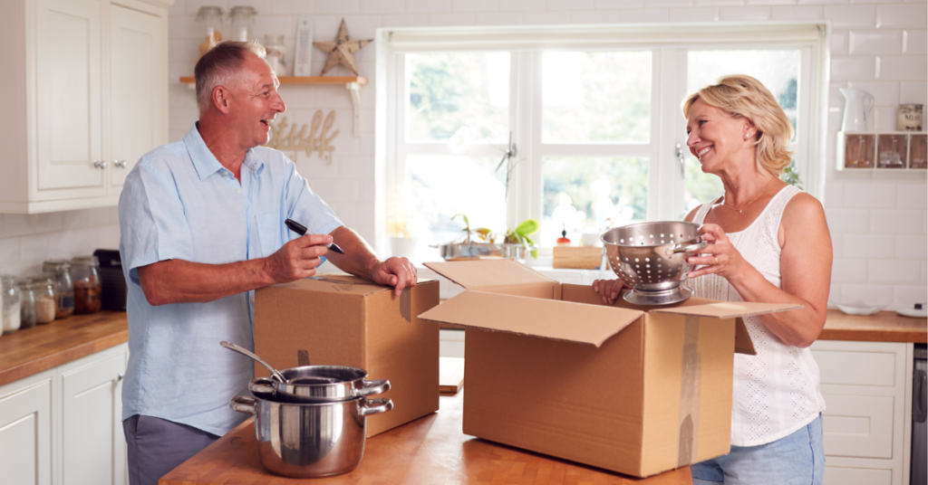Couple packing boxes while preparing to sell their home in Gainesville Florida